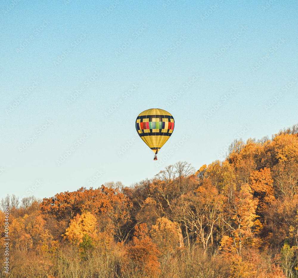 I captired this image one morning this past fall. You can see how the sky would change color as I took pictures from different angles, Hot air balloon floating free.