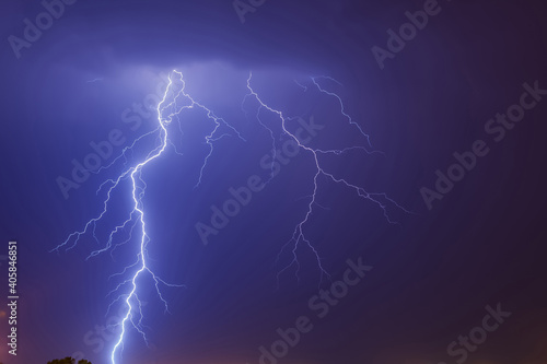 Mighty lightning strike in the purple shaded sky