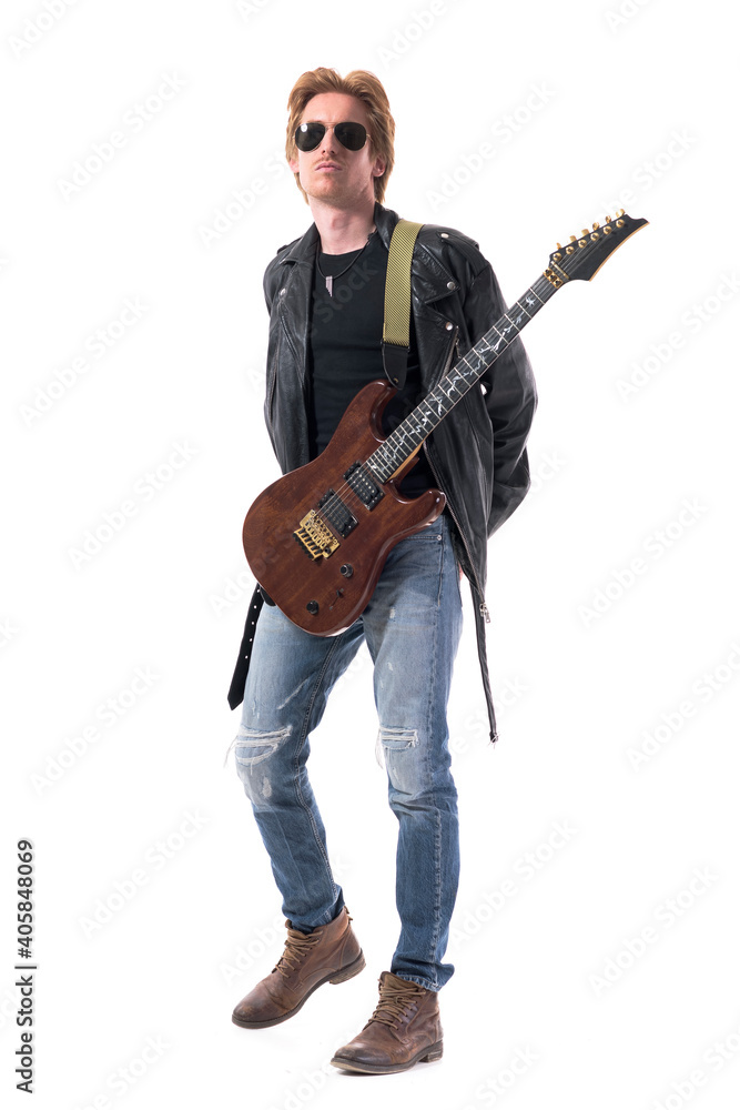 Cool attitude young handsome rock music guitarist with hands on back and electric guitar. Full body isolated on white background. Cool attitude young handsome rock music guitarist with hands on back and electric guitar. Full body isolated on white background.