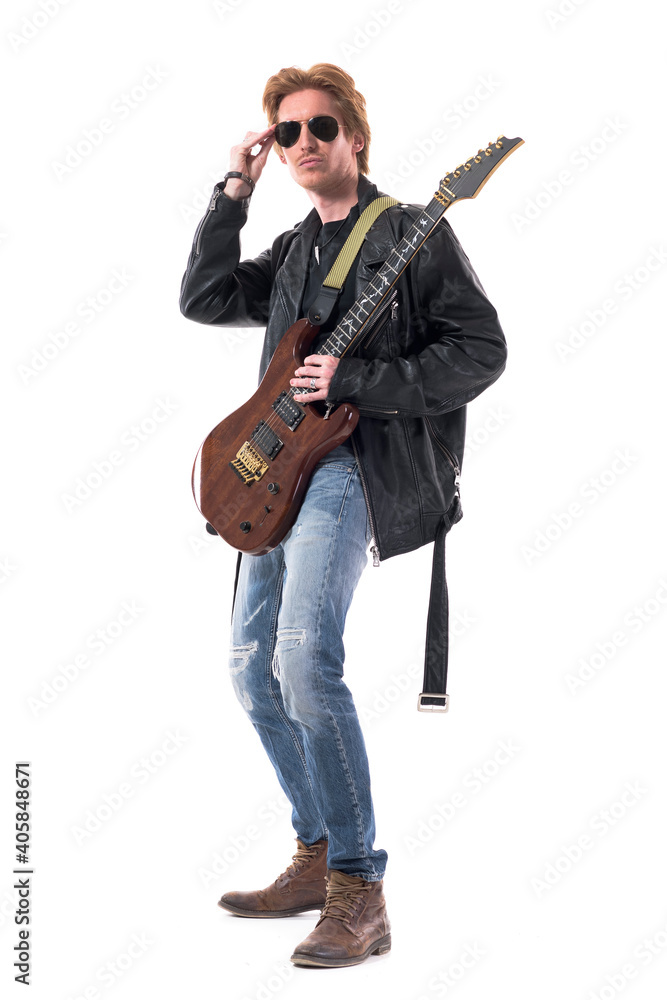 Fashionable redhead handsome rock music guitarist posing holding sunglasses. Full body isolated on white background. Fashionable redhead handsome rock music guitarist posing holding sunglasses. Full body isolated on white background.