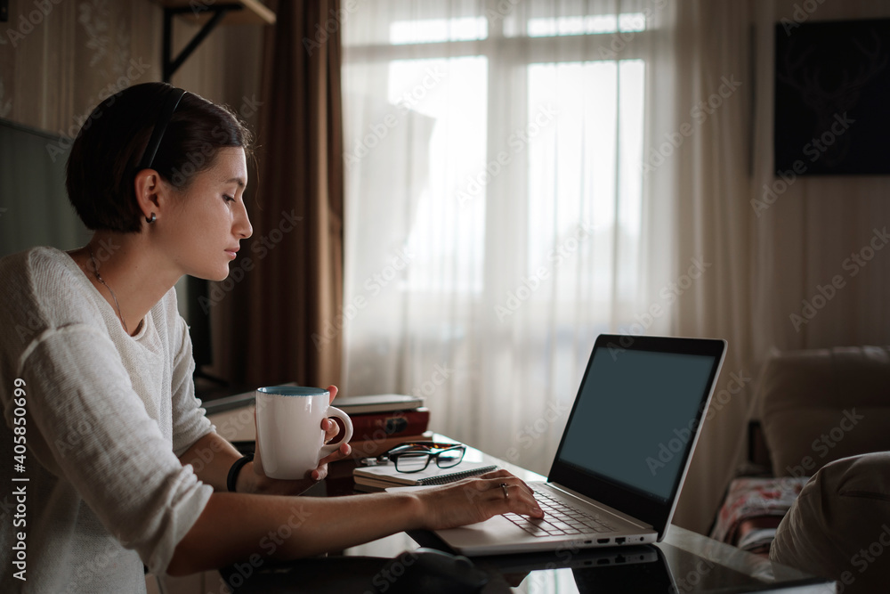 Smiling young asian woman video calling on laptop. Smiling young asian woman video calling on laptop.
