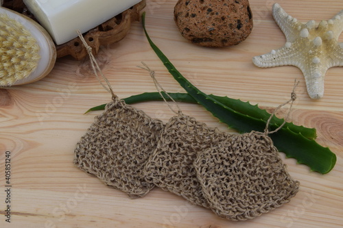 Natural jute body washcloth, zero waste concept, eco-friendly bath, crochet jute twine handmade on wooden background