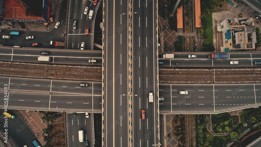 Top down cross traffic highway with cars, trucks aerial. Urban transportation at bridge road at metropolis city of Manila, Philippines, Asia. Cinematic cityscape of downtown freeway drone shot Top down cross traffic highway with cars, trucks aerial. Urban transportation at bridge road at metropolis city of Manila, Philippines, Asia. Cinematic cityscape of downtown freeway drone shot