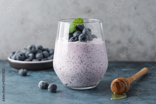 Blueberry chia pudding with fresh berries and honey. Healthy breakfast concept photo