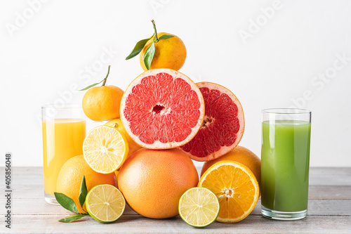 Creative composition of slices citrus fruit and glasses of juice. Seasonal fruits are source of vitamin C and strengthen immunity