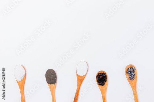 Lavender flowers in wooden spoons on white background