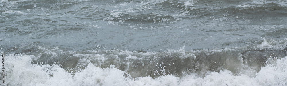 Fototapeta premium Winter seascape background, splashing water waves