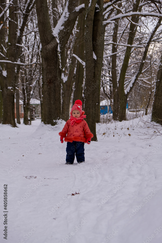 Little kid girl running on snow.
