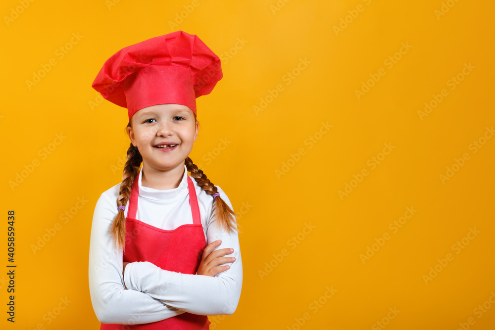 Portrait of a cute little girl chef on a yellow background. The child has crossed his arms and is looking at the camera. Portrait of a cute little girl chef on a yellow background. The child has crossed his arms and is looking at the camera.
