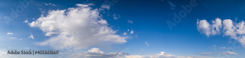 White cumulus  clouds and rainbow in summer evening  blue sky panoramic high resolution background