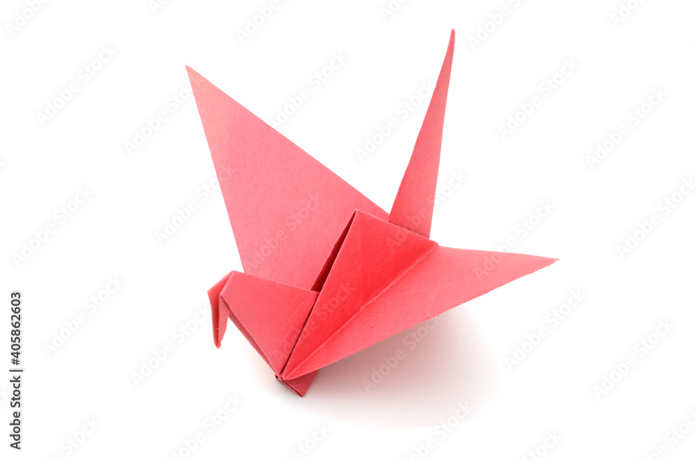 A red origami paper bird on paper background A red origami paper bird on paper background