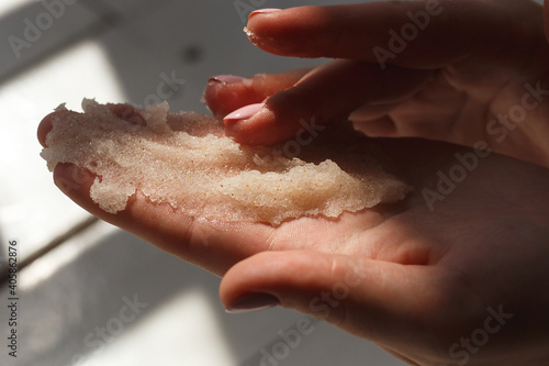 Oil salt scrub. Cosmetic surgery, hand peeling. Massage of female hands peeling preparation Spa and Wellness. photo