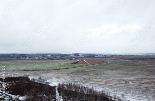 Top view of a snowy landscape with a field