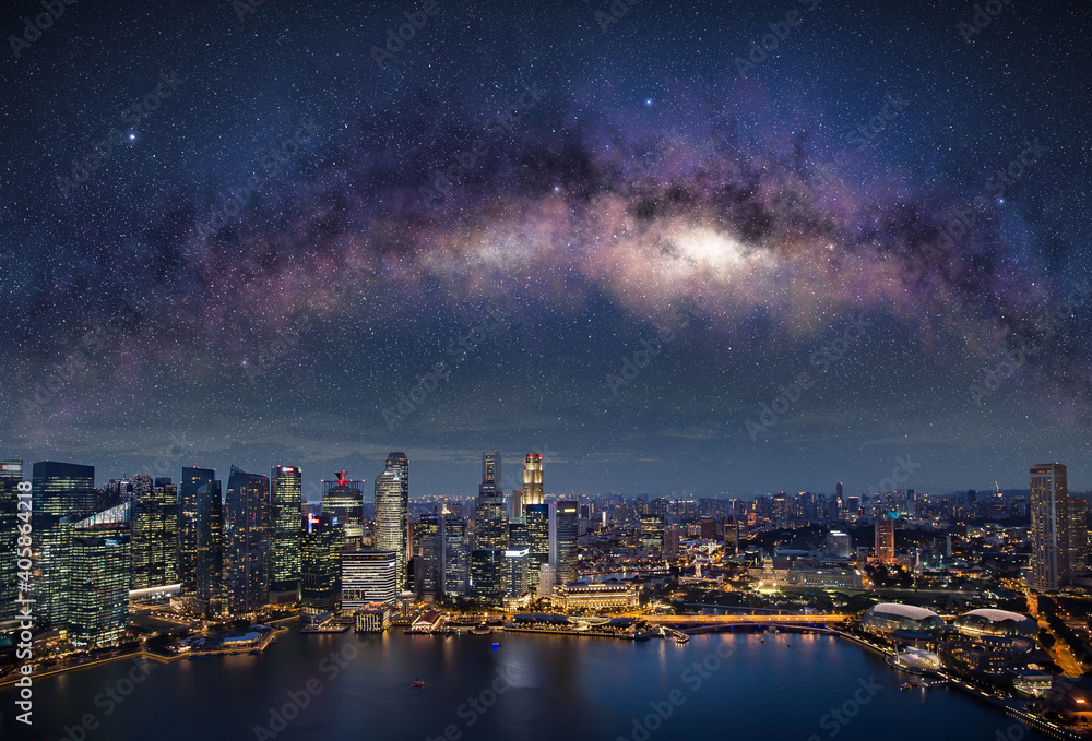 Obraz premium Milky way in Singapore night sky. Illuminated skyscrapers in central district waterfront.