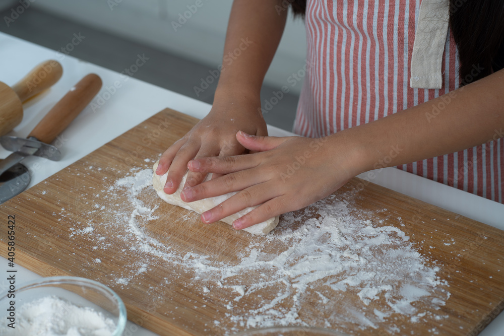 Asian girl learning cooking with mother in the kitchen Asian girl learning cooking with mother in the kitchen