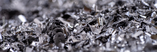 Metal shavings. Panoramic background of metallic chips. Processing of ferrous metals in a factory