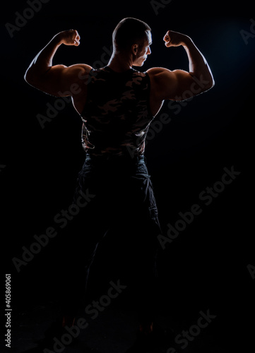 Fitness muscular body on dark background © qunica.com