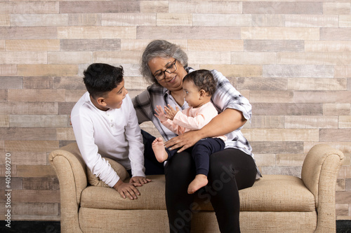 Happy moments with grandma, indian or asian senior lady spending quality time with her grand children 