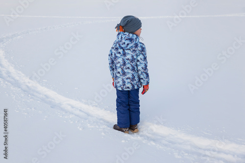 a boy playing in fresh snow