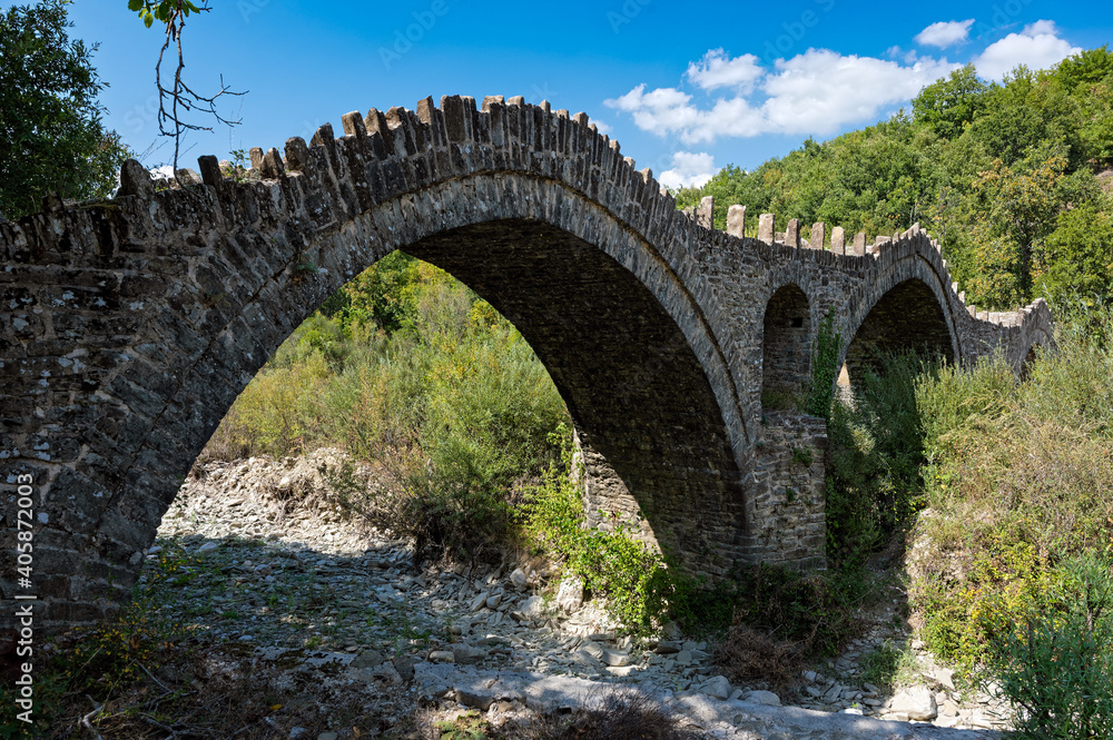 View of the traditional stone Kalouta Bridge in Epirus, Greece.