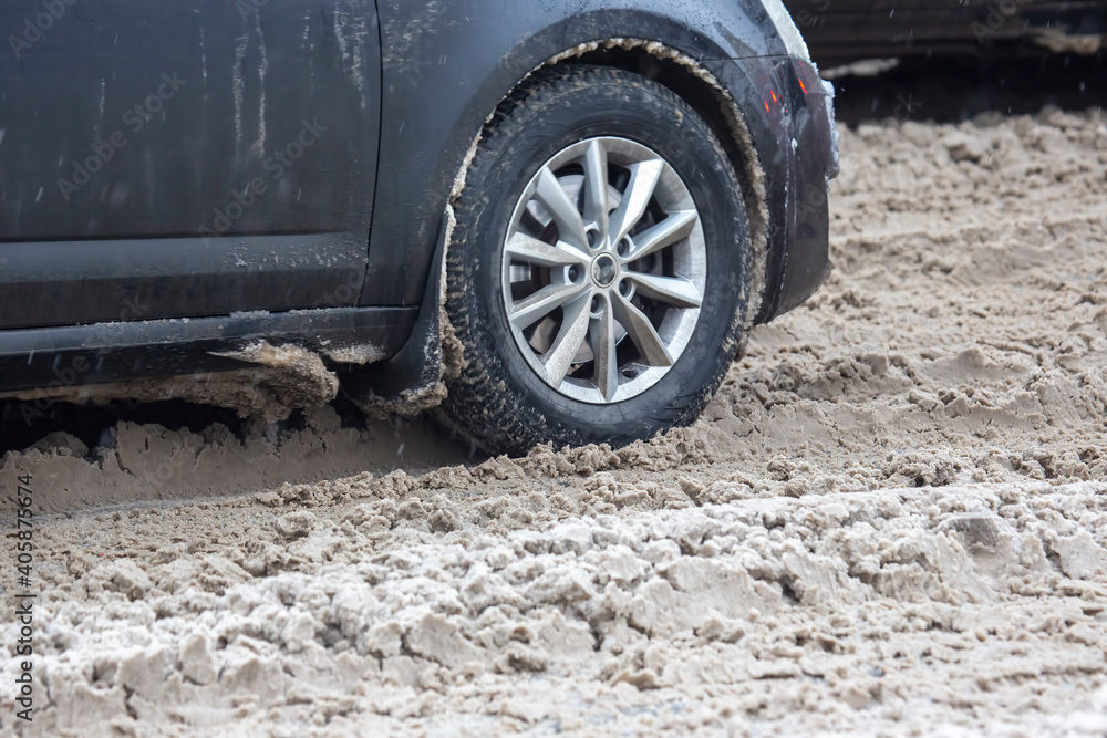 passenger car drives on a snowy road