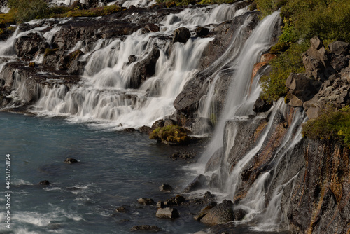 Hraunfossar waterfalls cascading into the Hvítá river over ledges of lava rock