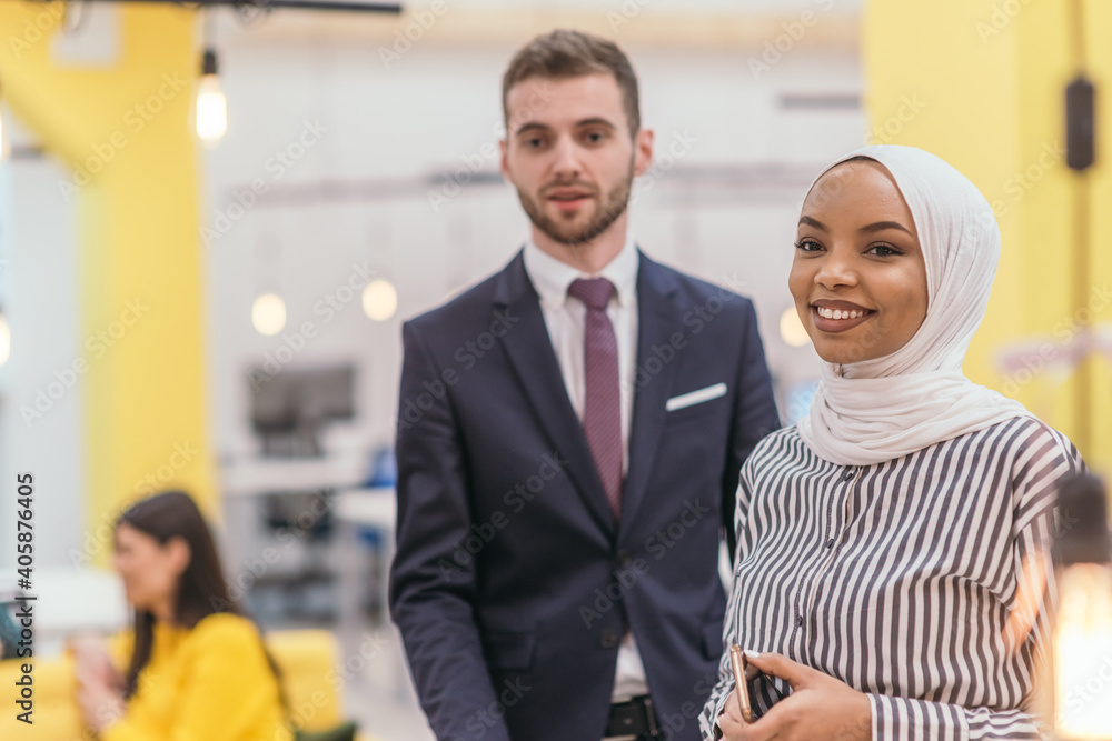 Portrait of a Muslim African American businesswoman at work while standing in the middle of a modern office. Portrait of a Muslim African American businesswoman at work while standing in the middle of a modern office.