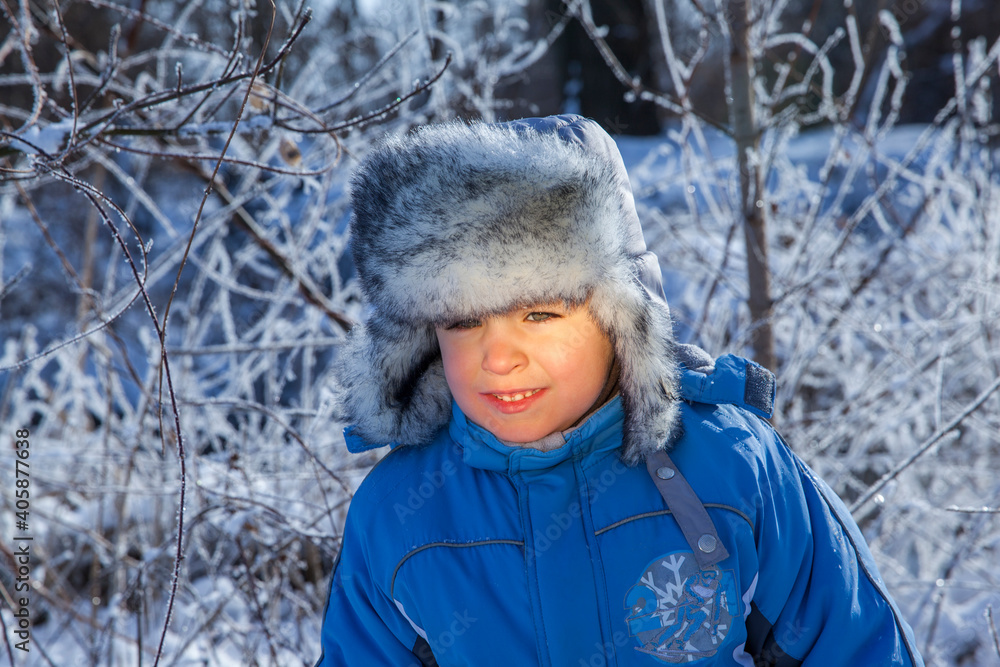 happy little boy in winter clothes on snow background happy little boy in winter clothes on snow background