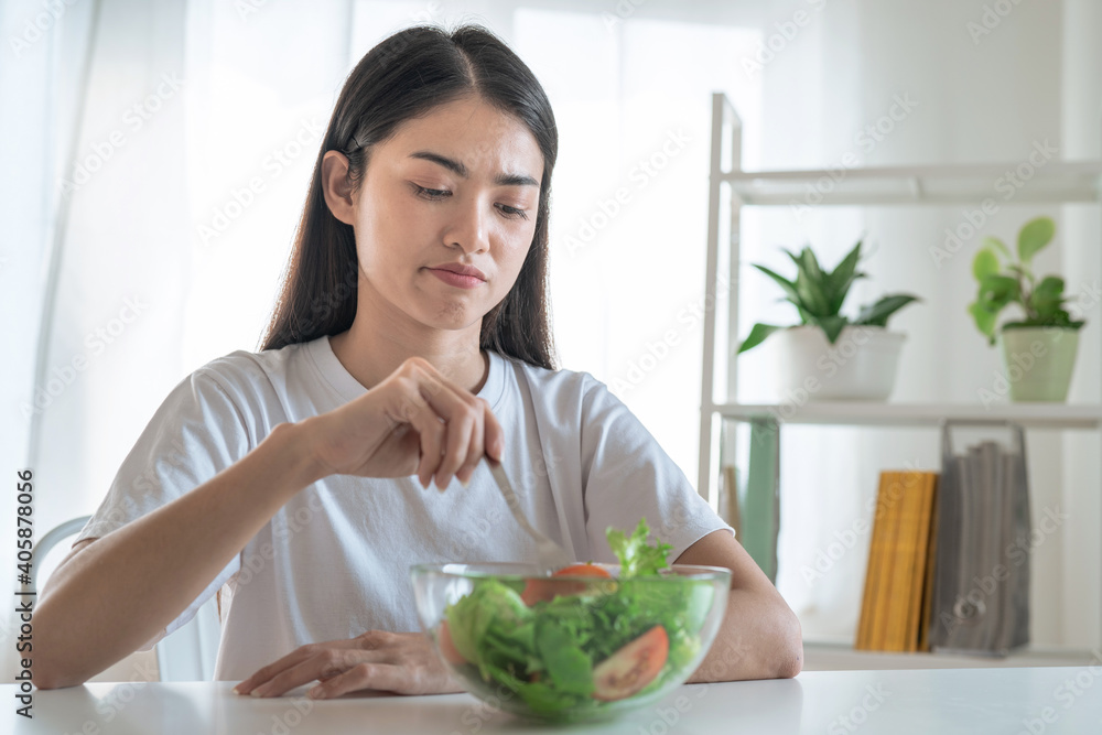 Asian women are not happy, She doesn't want to eat vegetables.