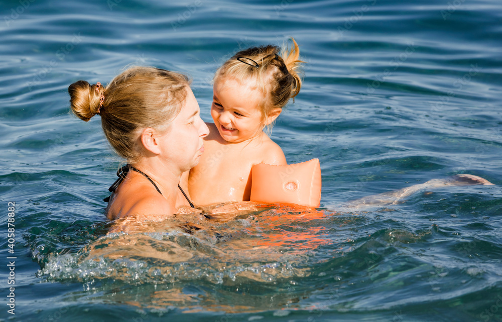 Mother with toddler girl in sea Mother with toddler girl in sea