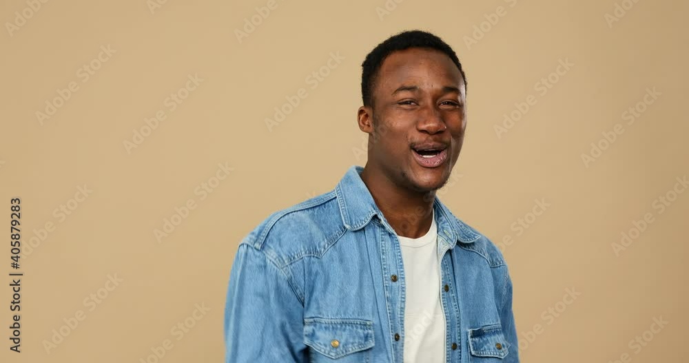 Man greeting and inviting to come over beige background Man greeting and inviting to come over beige background