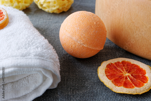 Orange bath bomb close view bathroom spa table. Spa accessory, skin and body care. photo