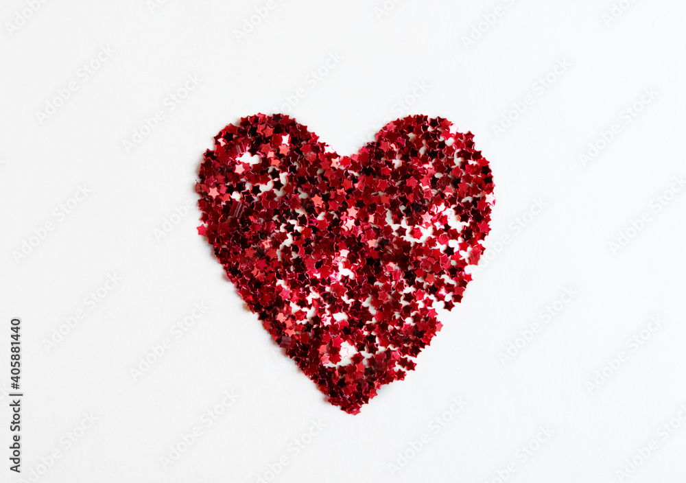 Greeting card heart made of red confetti on a white background.