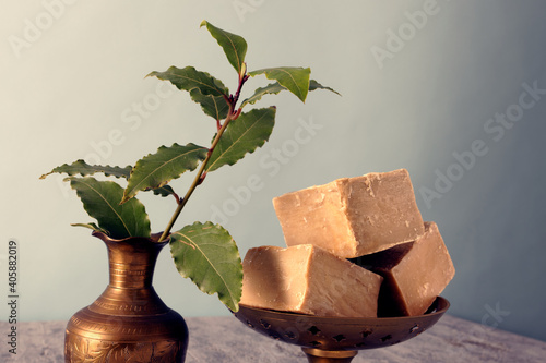 Natural soap with laurel branch (soap ingredient) in metal decorative vase. Traditional soap from Aleppo. photo