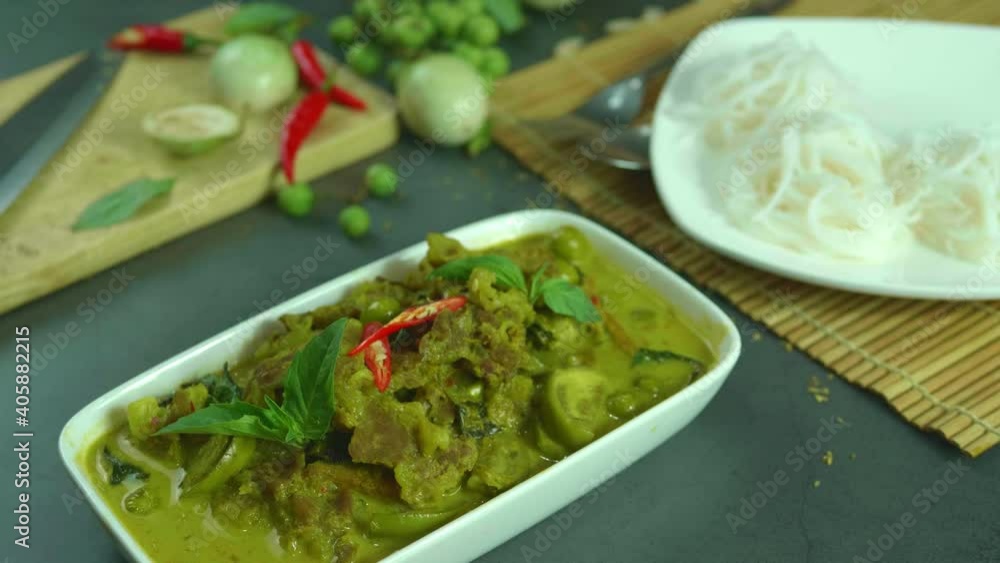 Green curry with beef. Famous food in Thailand. The food consists of curry paste. Blended with herbs Simmered with coconut milk And meat Season with fish sauce and sugar,add brinjal and sweet eggplant Green curry with beef. Famous food in Thailand. The food consists of curry paste. Blended with herbs Simmered with coconut milk And meat Season with fish sauce and sugar,add brinjal and sweet eggplant