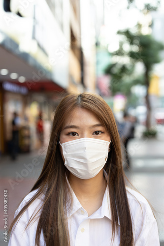 Girl wearing mask  at shopping center street © rakchai