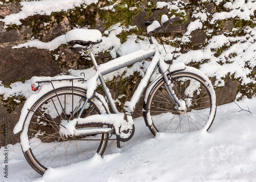 Bike covered with fresh snow.