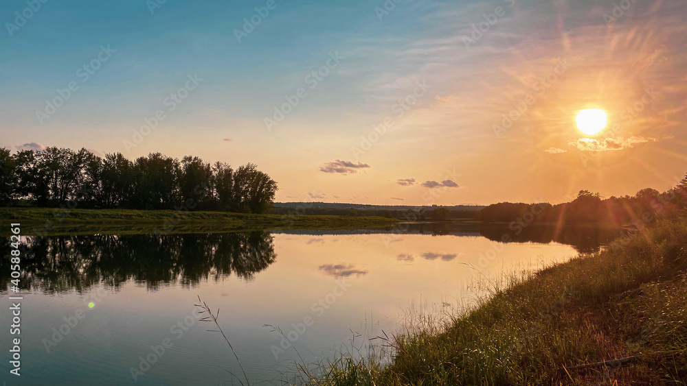 Naklejka premium sunset over the river