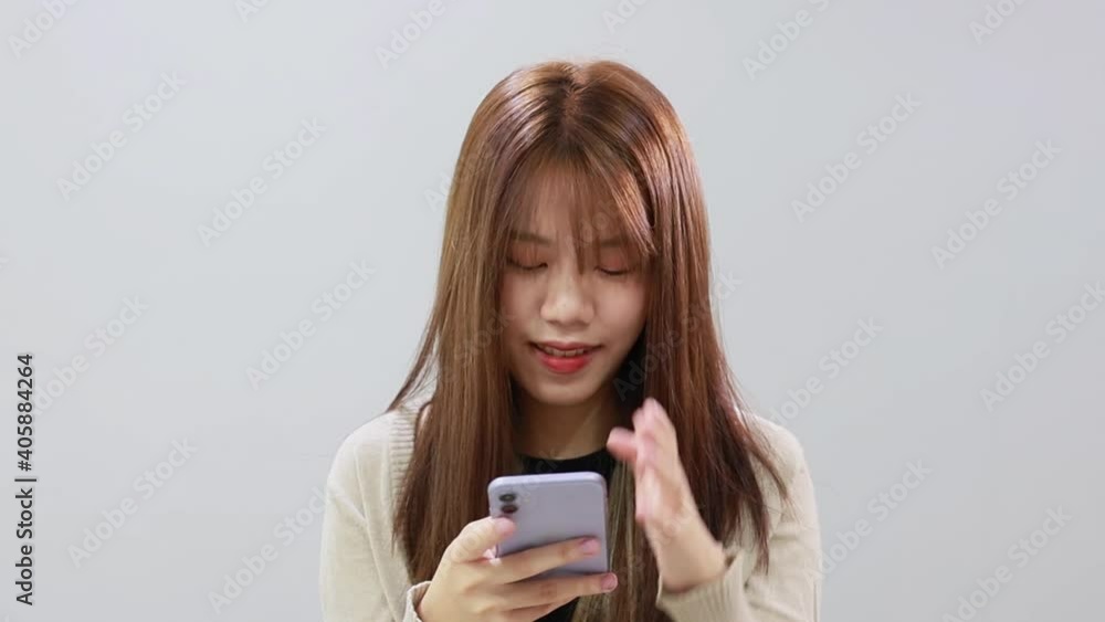 Isolated Asian girl with mobile phone Isolated Asian girl with mobile phone