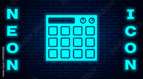 Glowing neon Drum machine music producer equipment icon isolated on brick wall background. Vector.