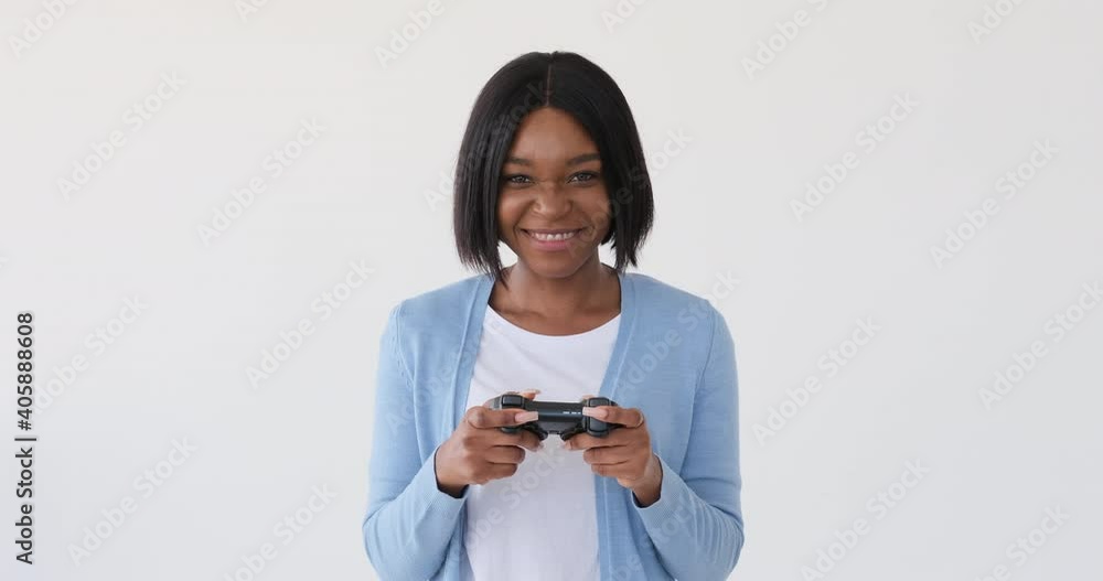 African American woman playing a video game match and celebrating win African American woman playing a video game match and celebrating win