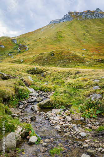 River flowing in the Val de Courre Valley with the Puy de Sancy Peak in the background