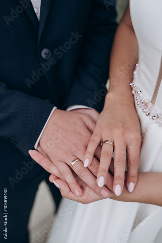 the bride and groom hold each other's hands