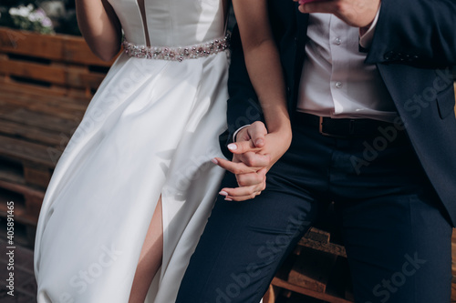 the bride and groom hold each other's hands