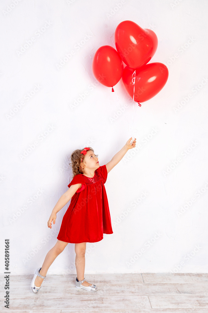 valentine's day kids. Little girl in red dress holding heart shaped balloons valentine's day kids. Little girl in red dress holding heart shaped balloons