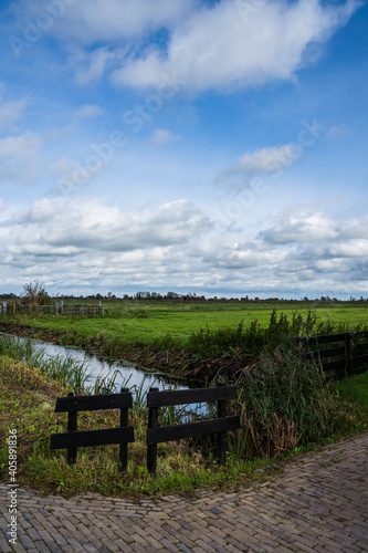 Dutch meadow next to canal, blue skies