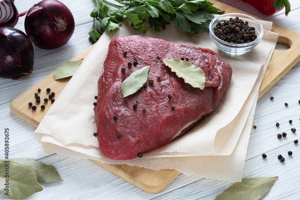 Raw meat beef on cutting board with spices