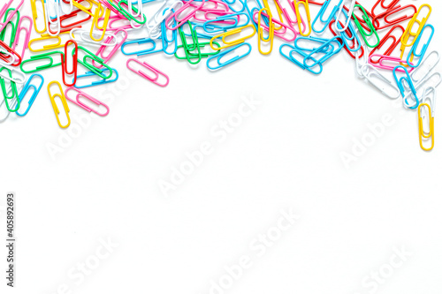 Close-up of multi-colored paper clips on a white background. Place for your text. Business and educate concept.
