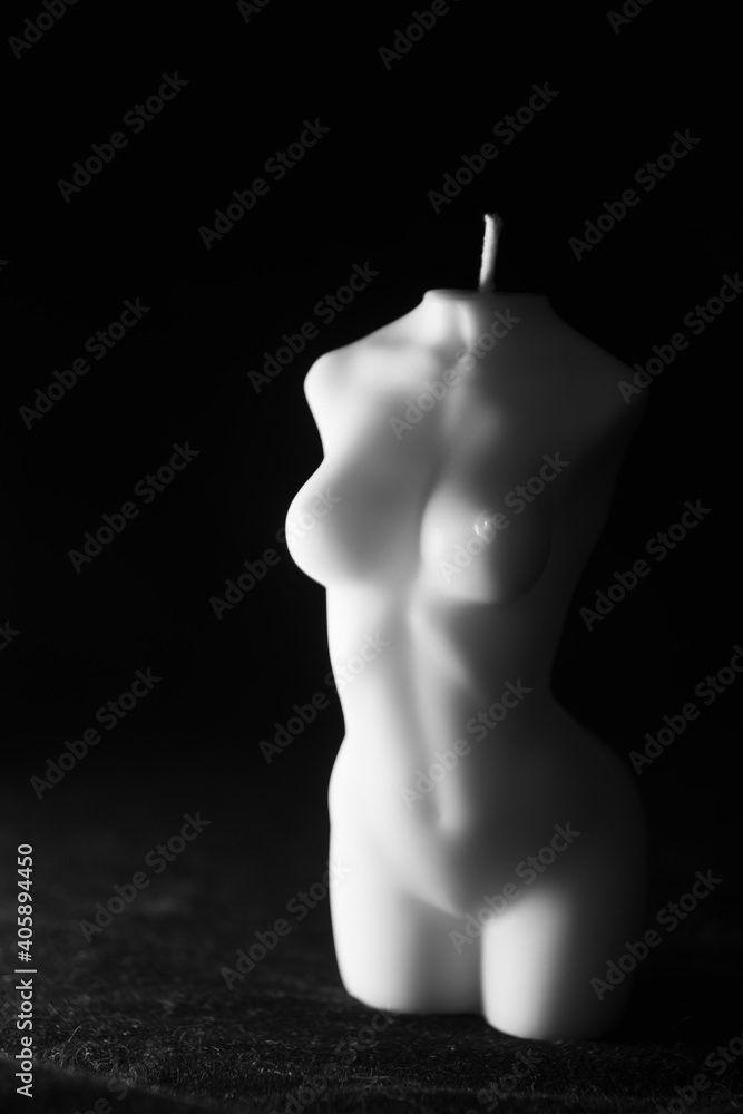 a candle in the form of a female body