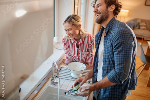 Lovely couple doing the dishes together